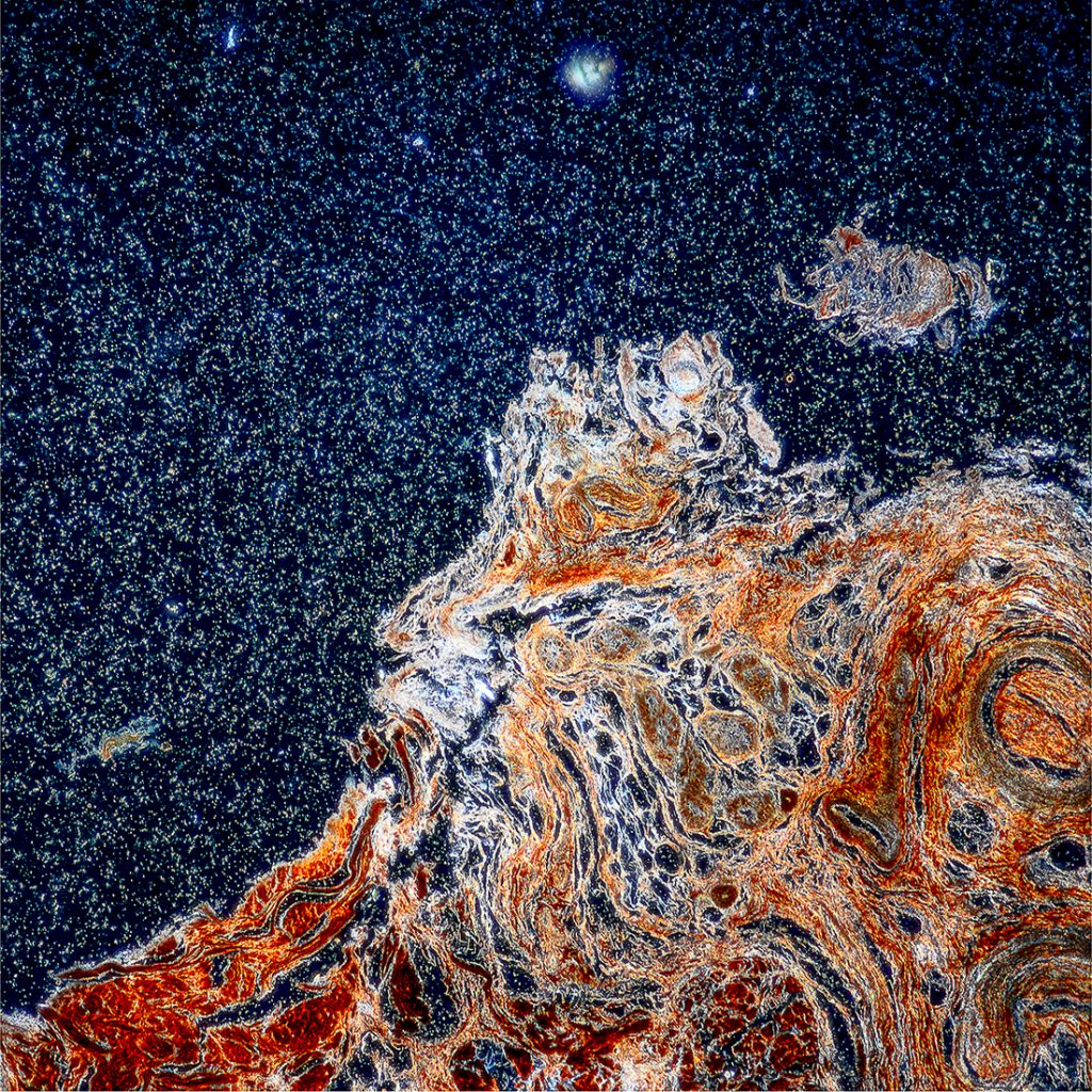 Half of the image is taken up by light blue-silver speckles on a dark background, which looks like a starry night sky. The other half contains swirls of shades of orange.