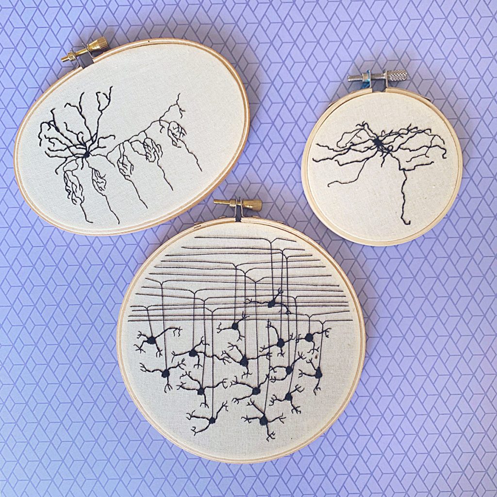 Three embroidery pieces that are part of Stitching Hew's 100 Neuron Project. They show three different types of neurons embroidered in black. 