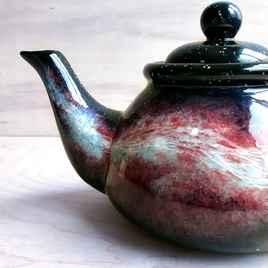 Teapot with long, thin red and blue Witch's Broom nebula stretching from the spout across the entire teapot
