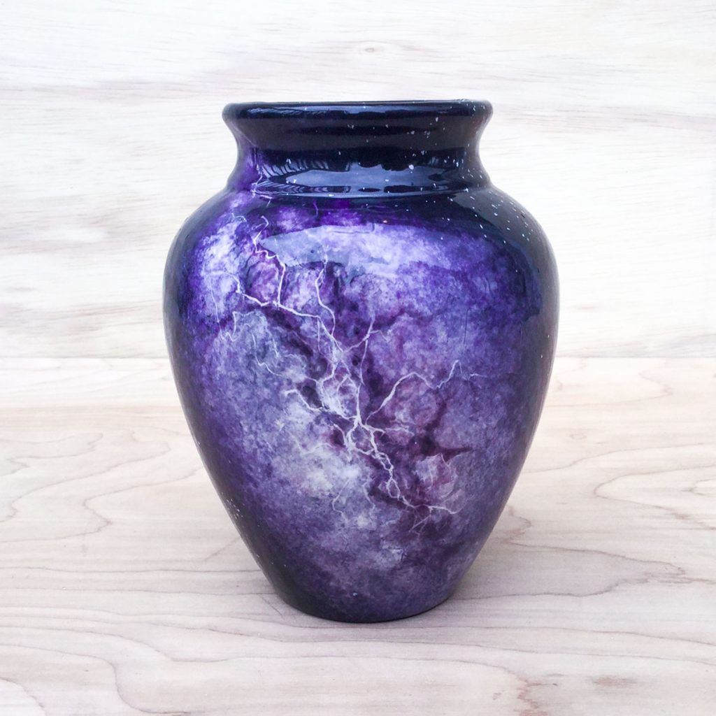 Vase with a purple Milky Way stretching diagonally along the length 