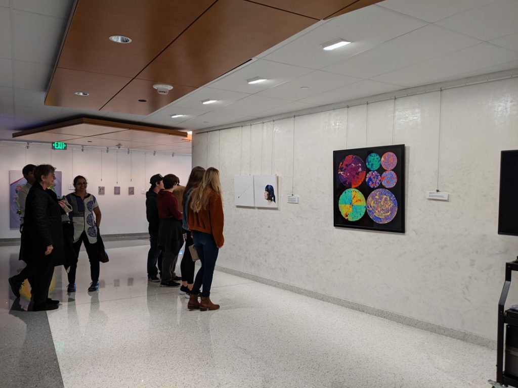 People looking at the sciart on display as part of the exhibition.