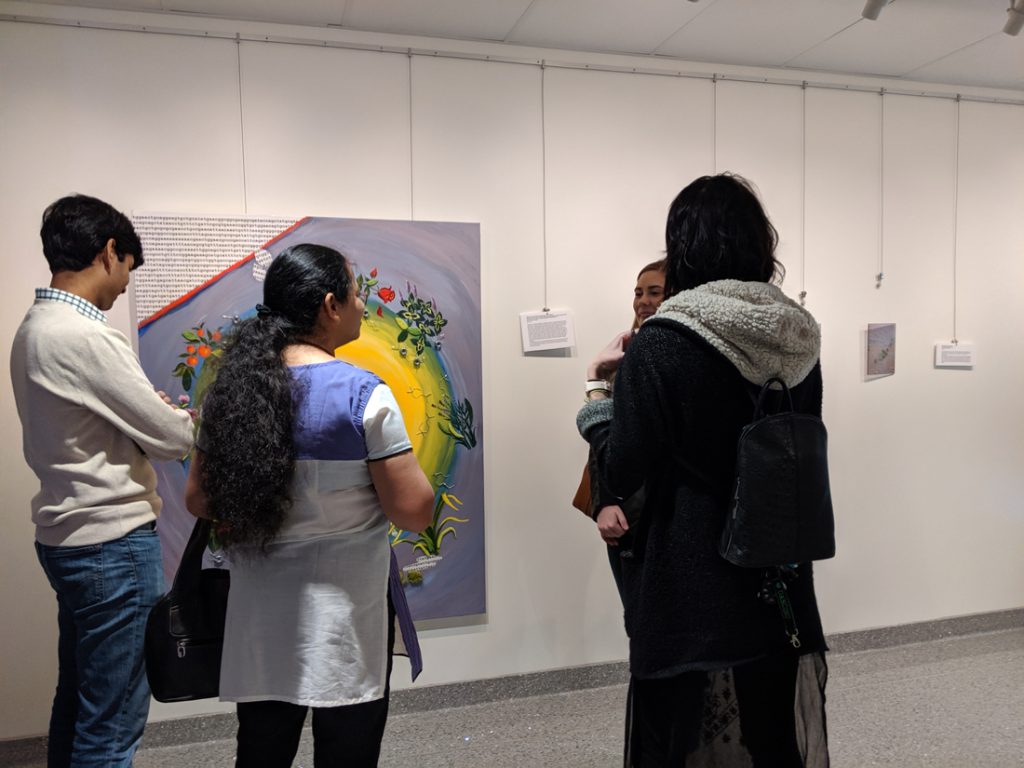 People looking at the sciart on display as part of the exhibition. 