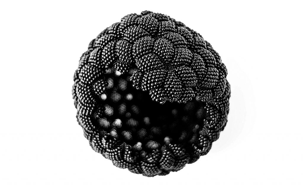 Black sphere made of joined beaded diamond shapes. Jagged hole in one side. 