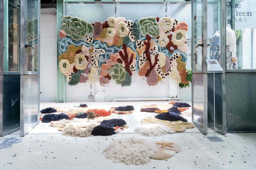 Large, colorful hanging tapestry in a display. 