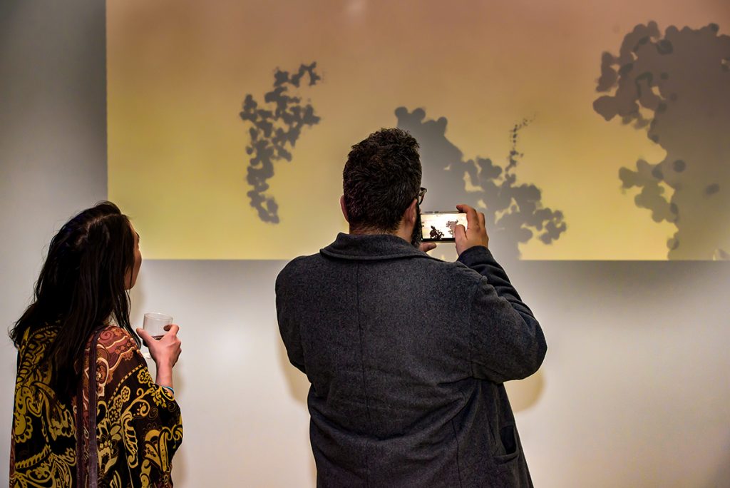 People looking at Owen's large Between the Sand installation at the Modern Fuel ARtist-Run Centre.