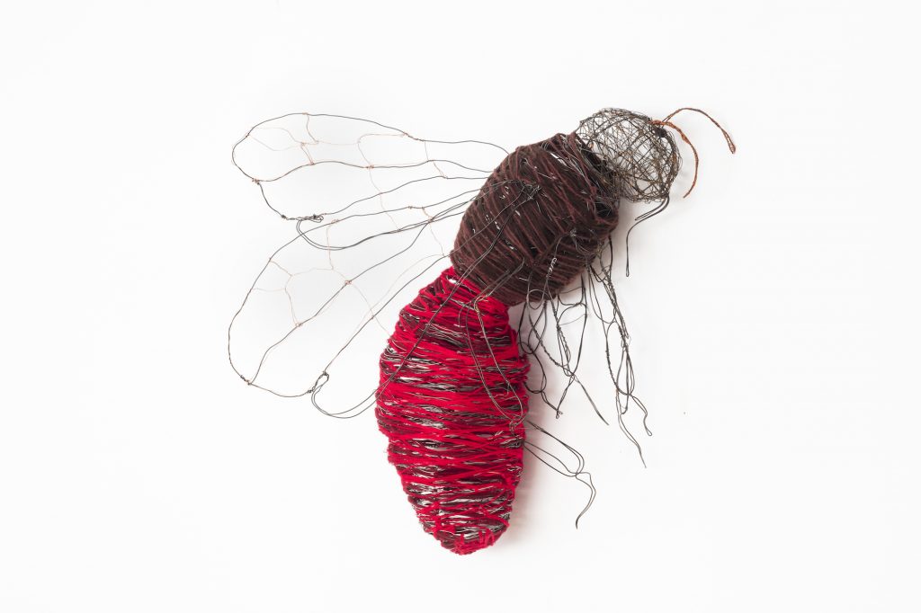 Bee made of wire with a bright red abdomen.