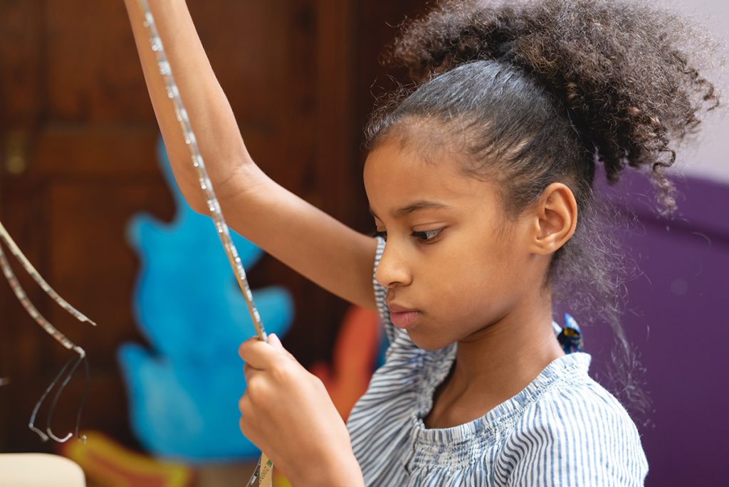 Girl working with a string of LED lights