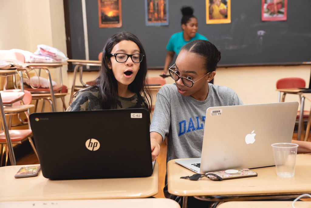 Girls working together on laptops