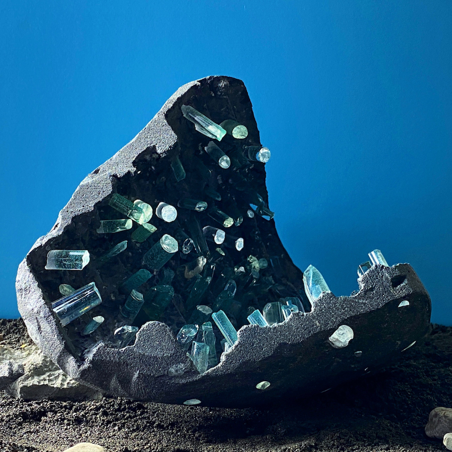 Grey concrete rock-like exterior with clera blue glass crystals inside