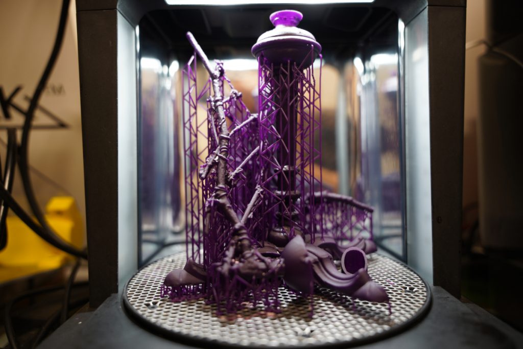 A purple lattice-like sculpture printed from a 3d printer.