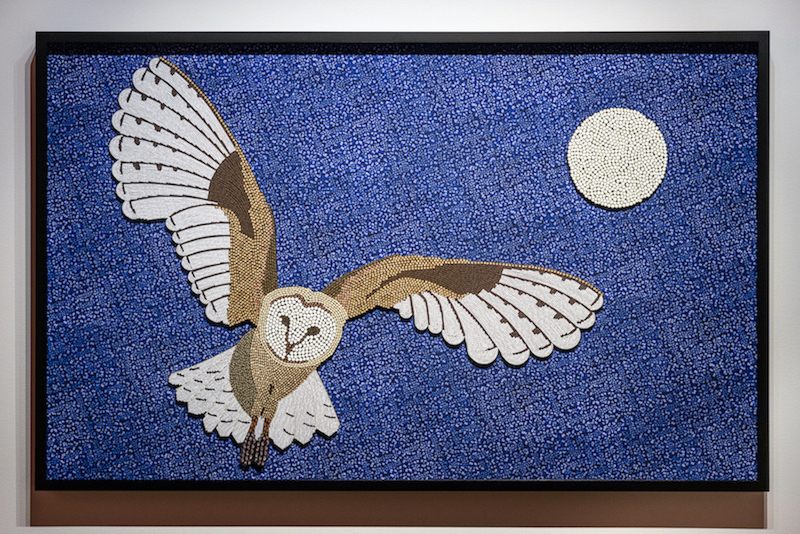 "Barn Owl and Moon" by Daphne Boyer. An image of an owl gliding through a starry night sky, the moon is high. The image is composed of digitally photographed berries.