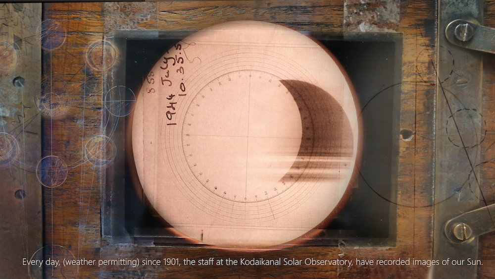 A copper-coloured disk with numbers arranged in a circle overlaid with a hand-written date reading 1944 July. A caption at the bottom reads "Every day, (weather permitting) since 1901, the staff at the Kodaikanal Solar Observatory, have recorded images of our Sun."